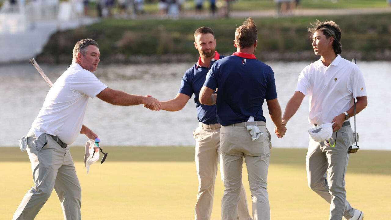 MEDINAH, ILLINOIS - SEPTEMBER 26: Ryan Fox of New Zealand and the International Team shakes hands with Wyndham Clark of the U.S. Team, Sam Burns of the U.S. Team and Min Woo Lee of Australia and the International Team on the 16th green during Saturday's Foursome matches on day three of the Presidents Cup 2026 at Medinah Country Club on September 26, 2026 in Medinah, Illinois.