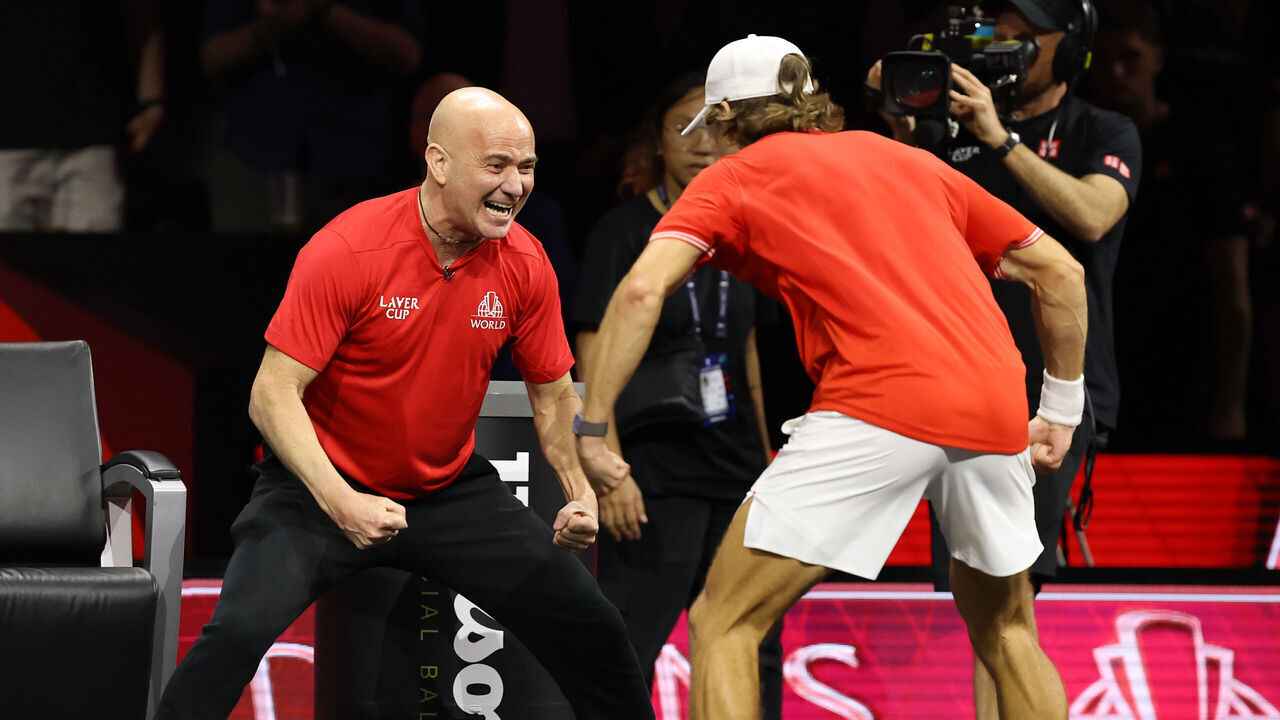 LONDON, ENGLAND - SEPTEMBER 26: Alex de Minaur of Team World celebrates with Team World Captain Andre Agassi after he wins his match against Alexander Zverev of Team Europe on day two of the 2026 Laver Cup between Team Europe and Team World at The O2 on September 26, 2026 in London, England.