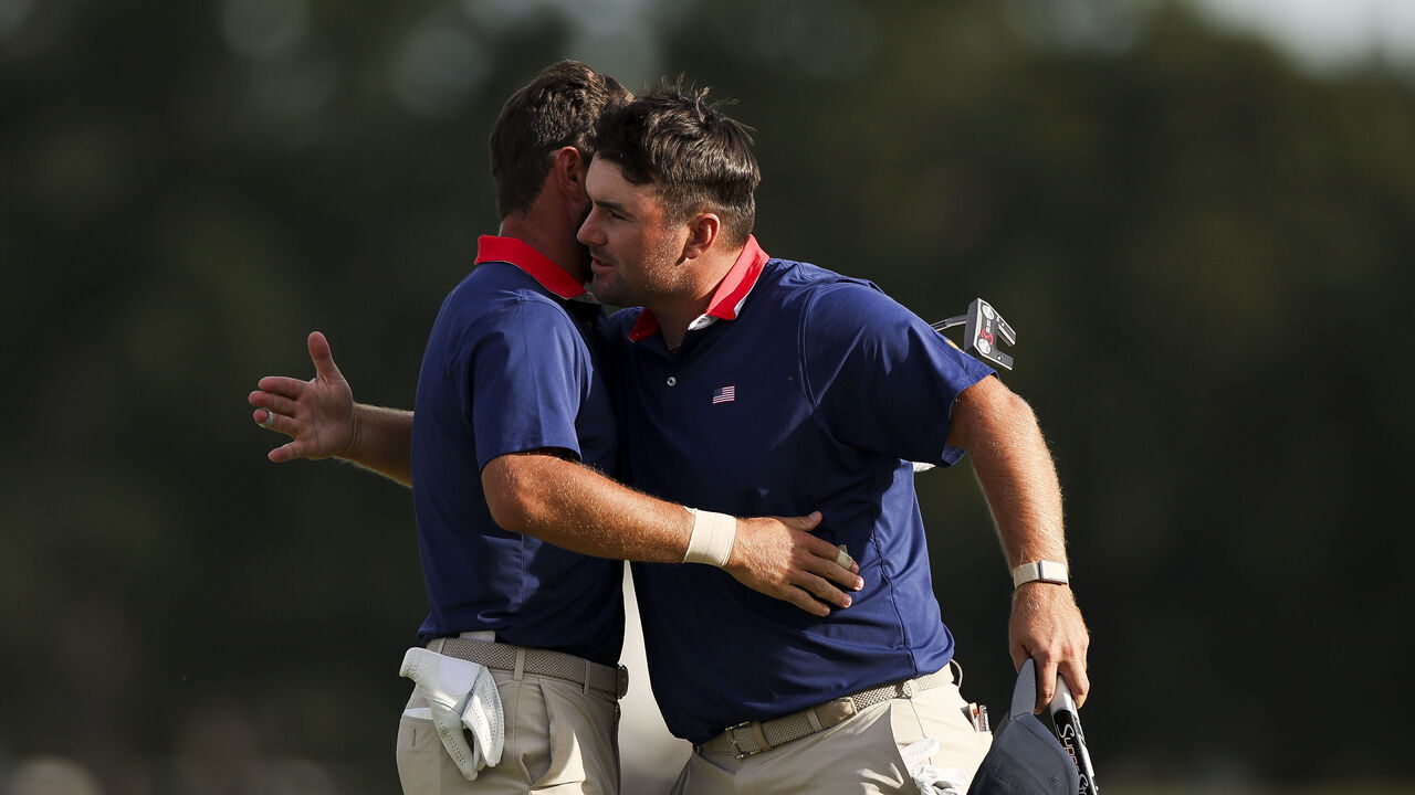 CHICAGO, ILLINOIS - SEPTEMBER 26: Cameron Young of the U.S. Team and teammate Chris Gotterup react on the 14th hole green after defeating Adam Scott and Sungjae Im of the International Team during Day Three of the Presidents Cup at Medinah Country Club Course No. 3 on September 26, 2026 in Chicago, Illinois.