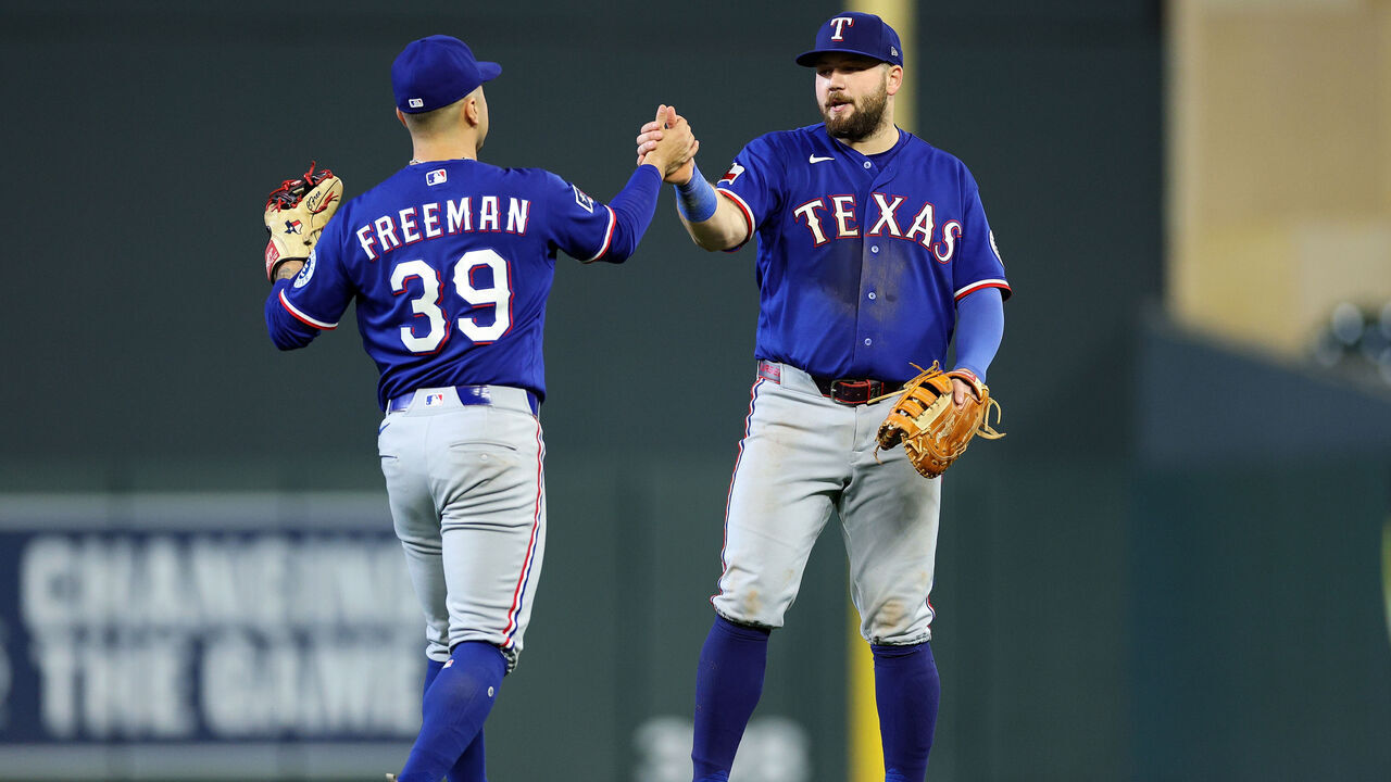 MINNEAPOLIS, MINNESOTA - SEPTEMBER 26: Cody Freeman #39 and Jake Burger #21 of the Texas Rangers celebrate the win against the Minnesota Twins after the game at Target Field on September 26, 2026 in Minneapolis, Minnesota. The Rangers defeated the Twins 6-2.