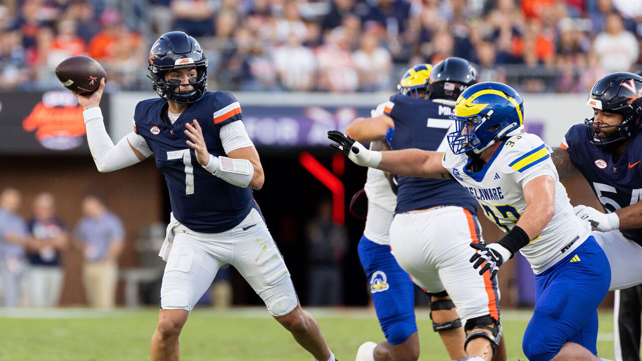 CHARLOTTESVILLE, VIRGINIA - SEPTEMBER 26: Beau Pribula #7 of the Virginia Cavaliers throws a pass over Trace Scott III #33 of the Delaware Blue Hens in the first half during a game at Scott Stadium on September 26, 2026 in Charlottesville, Virginia.
