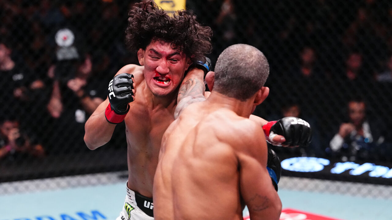 LAS VEGAS, NEVADA - SEPTEMBER 26: (L-R) Raul Rosas Jr. and Raoni Barcelos of Brazil trade punches in a bantamweight fight during the UFC Fight Night event at Meta APEX on September 26, 2026 in Las Vegas, Nevada.