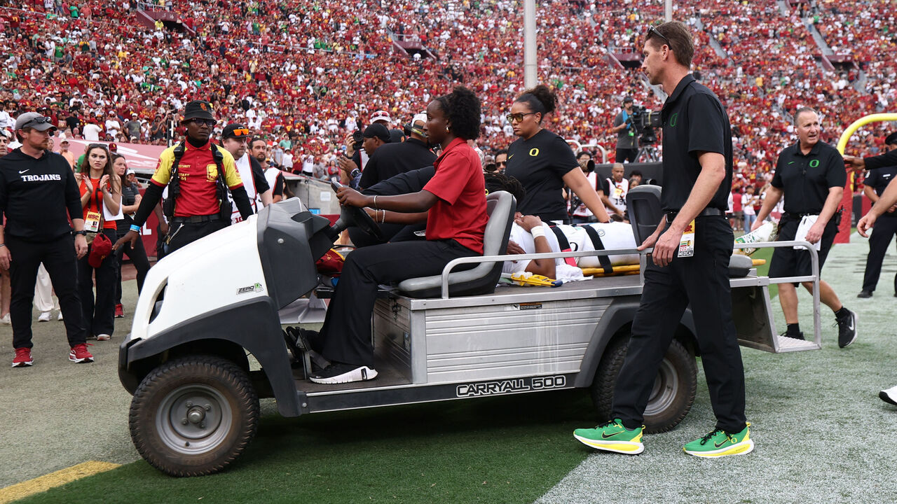 LOS ANGELES, CALIFORNIA - SEPTEMBER 26: Quarterback Dante Moore of the Oregon Ducks leaves the field on a stretcher in the first half of a game against the USC Trojans at Los Angeles Memorial Coliseum on September 26, 2026 in Los Angeles, California.