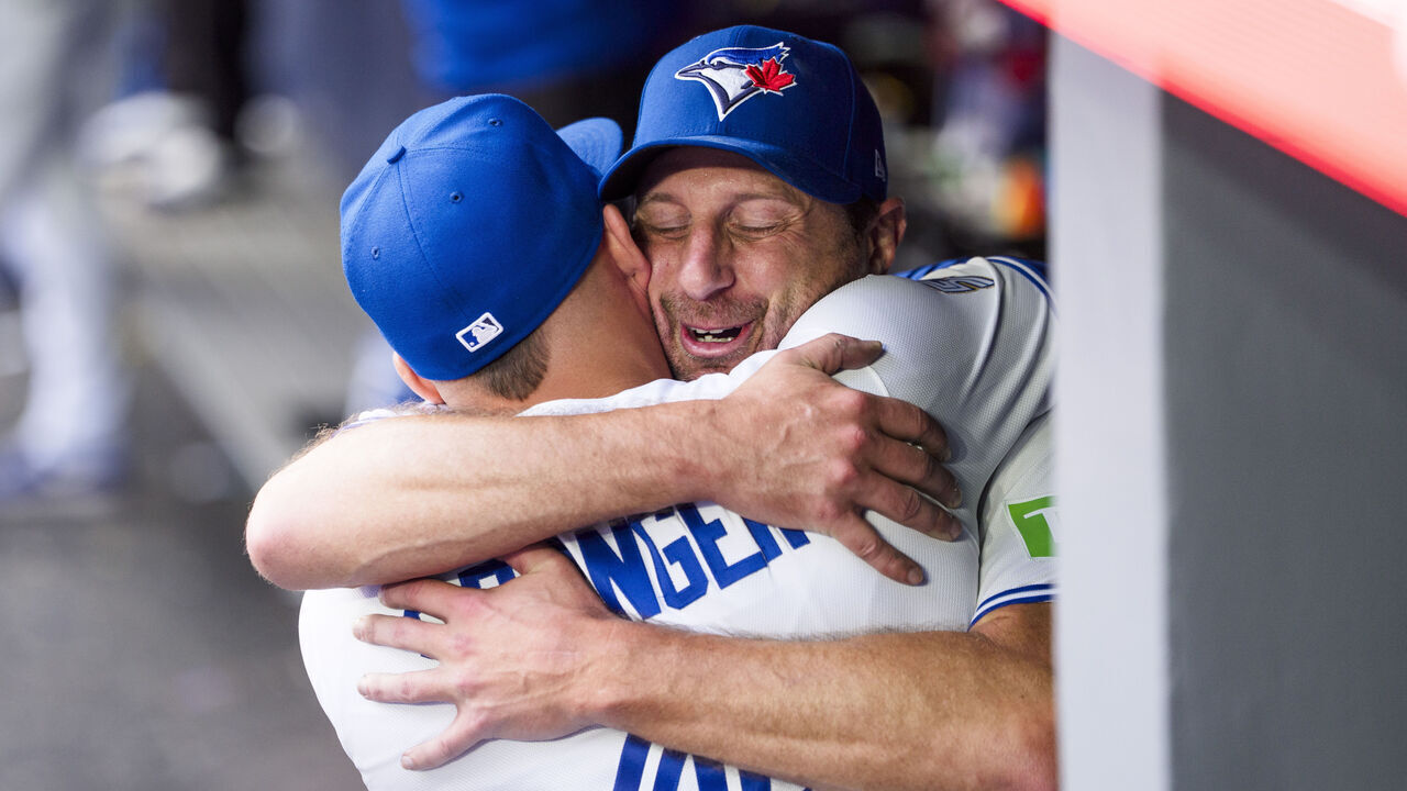 TORONTO, CANADA - SEPTEMBER 27: Max Scherzer #31 and George Springer #4 and of the Toronto Blue Jays hug after Scherzer was taken out of the game against the Cincinnati Reds during the eighth inning in their MLB game at Rogers Centre on September 27, 2026 in Toronto, Canada.