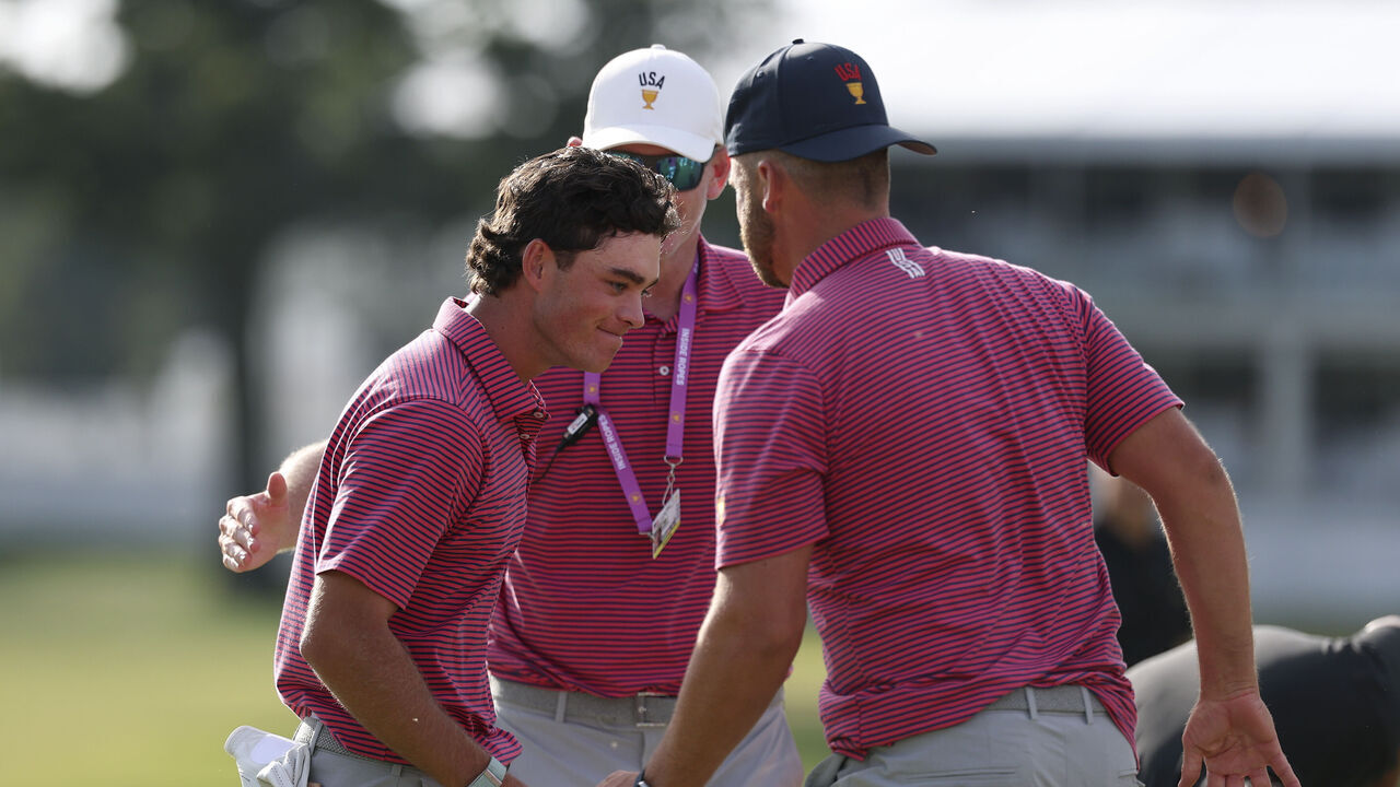 MEDINAH, ILLINOIS - SEPTEMBER 27: Wyndham Clark of the U.S. Team and Captain Brandt Snedeker of the U.S. Team congratulate Jackson Koivun of the U.S. Team after his win on the 18th green during Sunday's Singles on day four of the Presidents Cup 2026 at Medinah Country Club on September 27, 2026 in Medinah, Illinois.