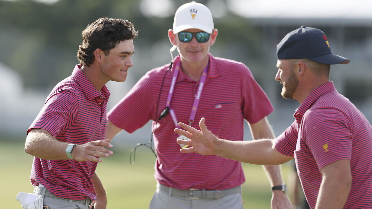 MEDINAH, ILLINOIS - SEPTEMBER 27: Wyndham Clark of the U.S. Team and Captain Brandt Snedeker of the U.S. Team congratulate Jackson Koivun of the U.S. Team after his win on the 18th green during Sunday's Singles on day four of the Presidents Cup 2026 at Medinah Country Club on September 27, 2026 in Medinah, Illinois.