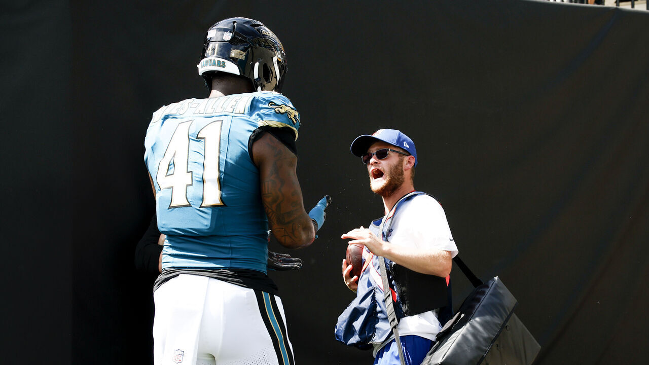 JACKSONVILLE, FL - SEPTEMBER 27: Defensive End Josh Hines-Allen #41 of the Jacksonville Jaguars confronts an NFL sideline ball attendant after trying to retrieve a football following teammate Travis Hunter's first career NFL interception during the first half of the game against the New England Patriots at EverBank Stadium on September 27, 2026 in Jacksonville, Florida.