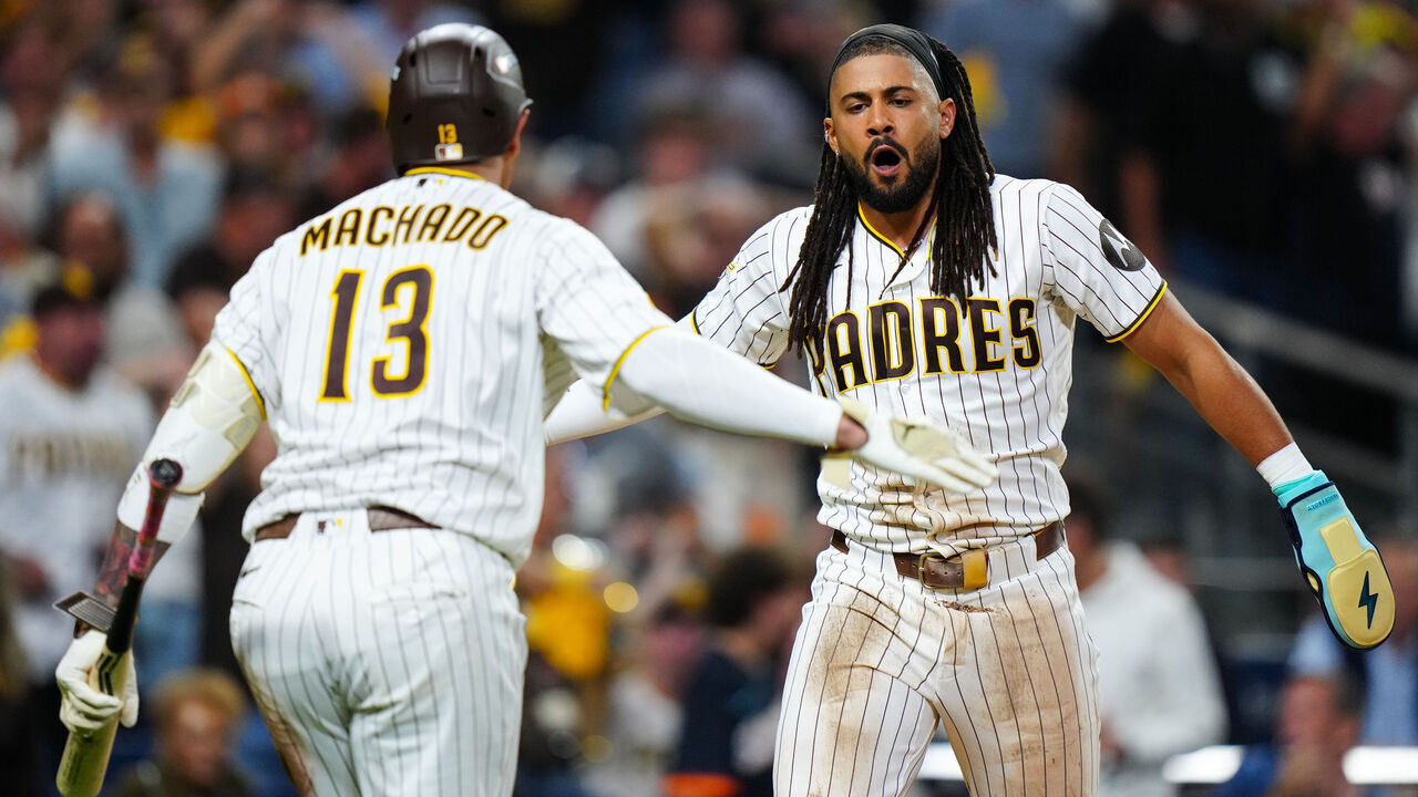 SAN DIEGO, CA - SEPTEMBER 29: Fernando Tatis Jr. #23 of the San Diego Padres celebrates with Manny Machado #13 at home plate after scoring in the seventh inning during Game One of the National League Wild Card Series presented by AbbVie between the Chicago Cubs and the San Diego Padres at Petco Park on Tuesday, September 29, 2026 in San Diego, California.