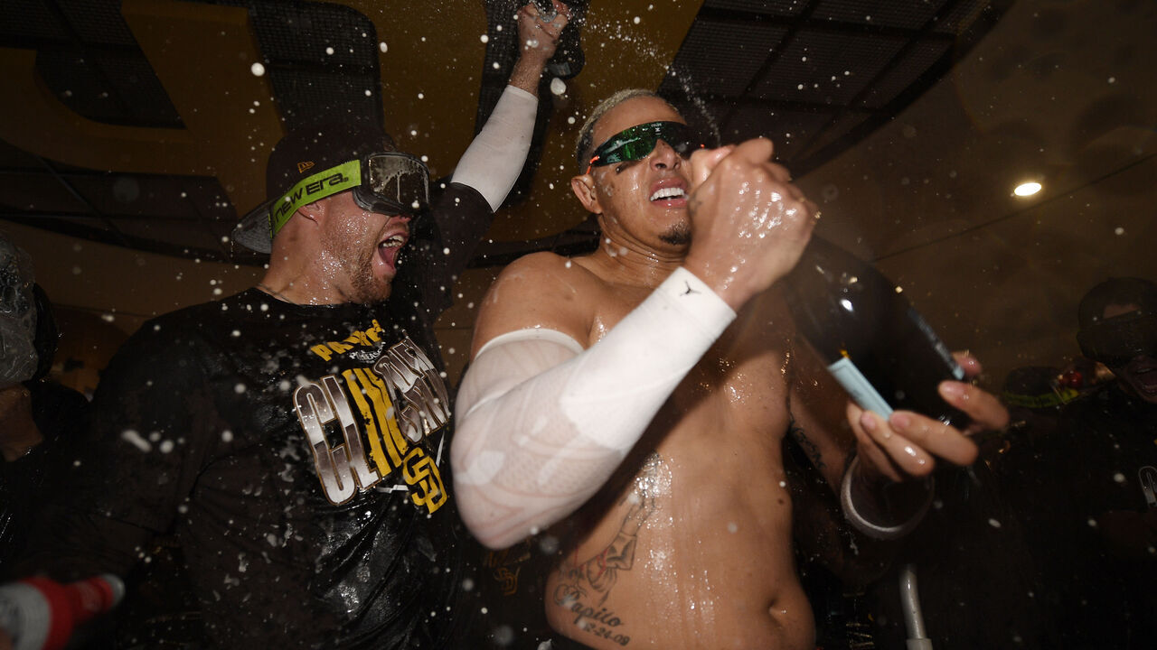 SAN DIEGO, CALIFORNIA - SEPTEMBER 30: Gavin Sheets #30 and Manny Machado #13 of the San Diego Padres celebrate in the clubhouse after defeating the Chicago Cubs in game two of the National League Wild Card Series at Petco Park on September 30, 2026 in San Diego, California.