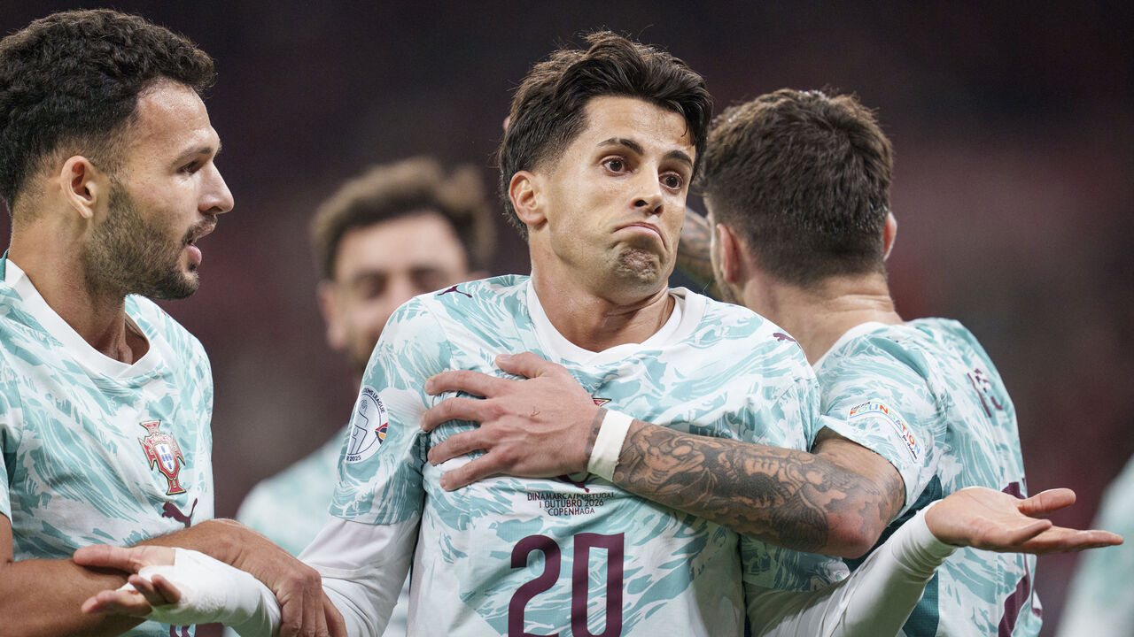 Portugal's defender #20 Joao Cancelo (C) celebrates scoring the opening goal with his teammates during the UEFA Nations League Group A4 match between Denmark and Portugal at Parken stadium in Copenhagen on October 1, 2026. / Denmark OUT