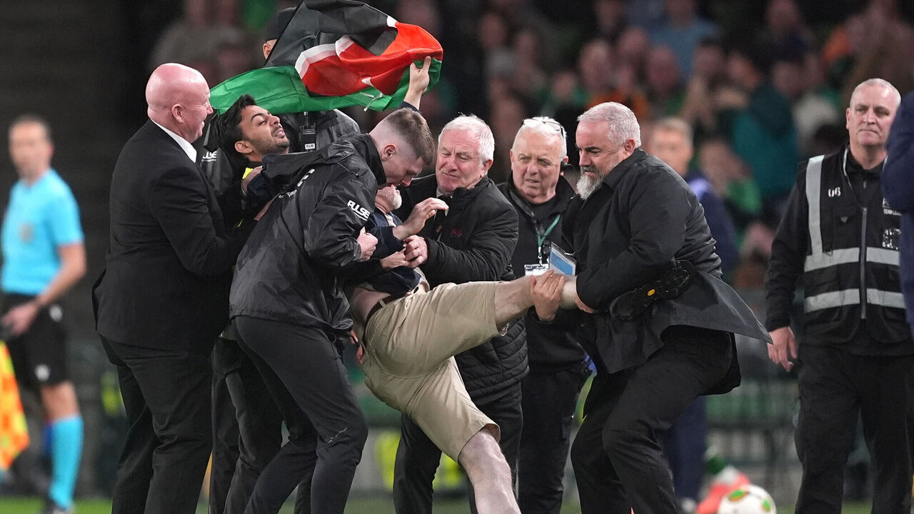 A protestor is escorted off the field by security during the UEFA Nations League, Group B3 match at the Aviva Stadium in Dublin, Ireland. Picture date: Thursday October 1, 2026.