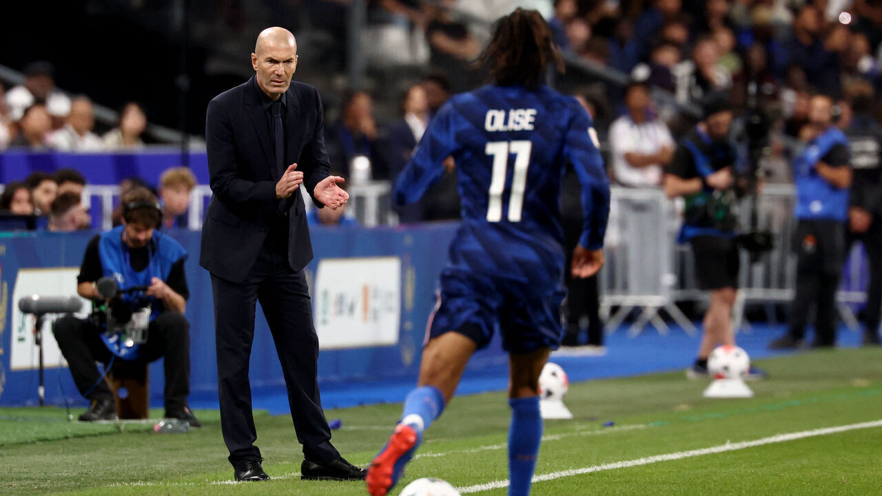 France's head coach Zinedine Zidane (L) applauds as France's midfielder #11 Michael Olise dribbles by during the UEFA Nations League, league A day 3: Group 1, football match between France and Italy at the Stade de France stadium in Saint-Denis, near Paris, on October 2, 2026.