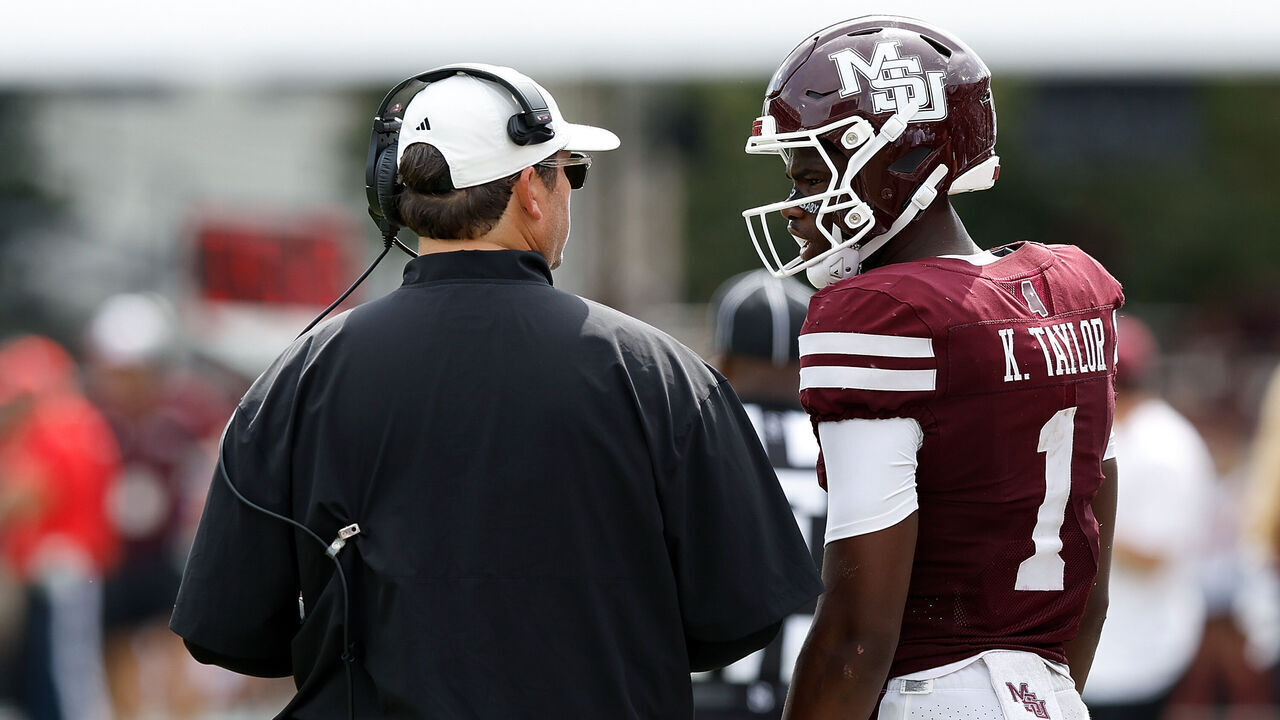 STARKVILLE, MISSISSIPPI - OCTOBER 03: Jeff Lebby of the Mississippi State Bulldogs and Kamario Taylor #1 of the Mississippi State Bulldogs talk during the second half against the Alabama Crimson Tide at Davis Wade Stadium on October 03, 2026 in Starkville, Mississippi.