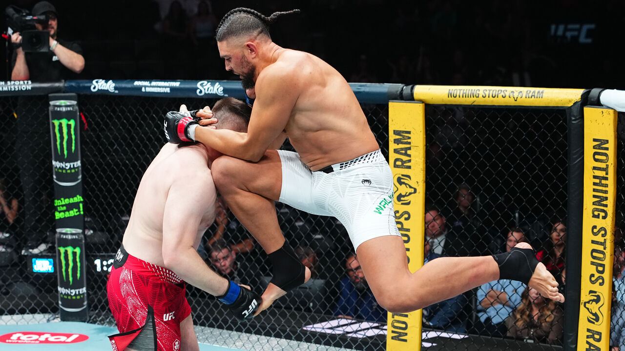 SALT LAKE CITY, UTAH - OCTOBER 03: Johnny Walker of Brazil knees Mick Parkin of England in a heavyweight fight during the UFC 332 event at Delta Center on October 03, 2026 in Salt Lake City, Utah.