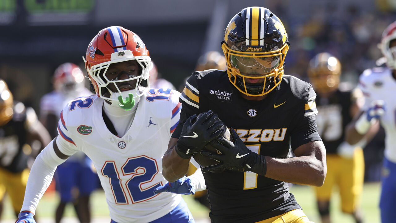 COLUMBIA, MO - OCTOBER 03: Ben Hanks III #12 of the Florida Gators pursues Donovan Olugbode #1 of the Missouri Tigers after a catch in the first quarter an SEC football game between the Florida Gators and Missouri Tigers on Oct 3, 2026 at Memorial Stadium in Columbia, MO.