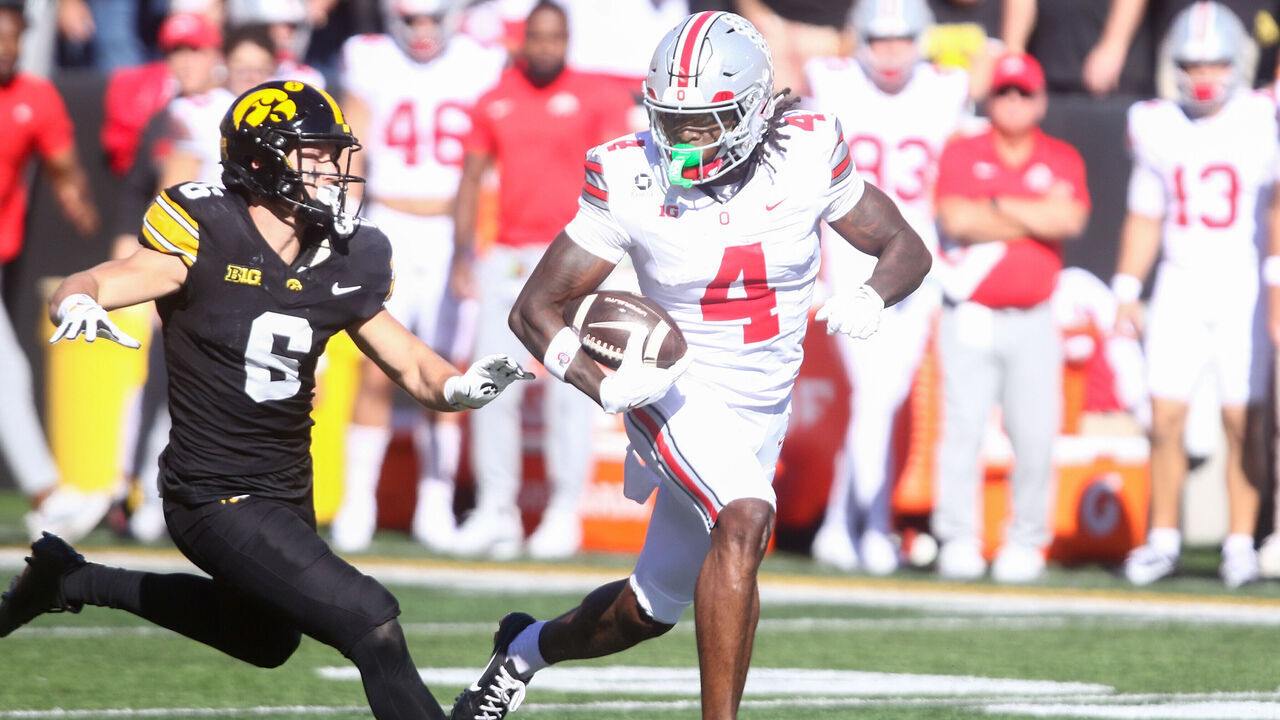IOWA CITY, IA - OCTOBER 3: Wide receiver Jeremiah Smith #4 of the Ohio State Buckeyes goes up the field in the first half against defensive back Zach Lutmer # 6 of the Iowa Hawkeyes at Kinnick Stadium on October 3, 2026 in Iowa City, Iowa.