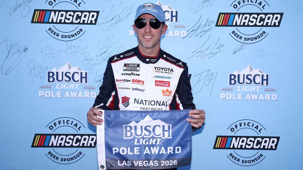 LAS VEGAS, NEVADA - OCTOBER 03: Denny Hamlin, driver of the #11 National Debt Relief Toyota, poses for photos after winning the pole award during qualifying for the NASCAR Cup Series South Point 400 at Las Vegas Motor Speedway on October 03, 2026 in Las Vegas, Nevada.