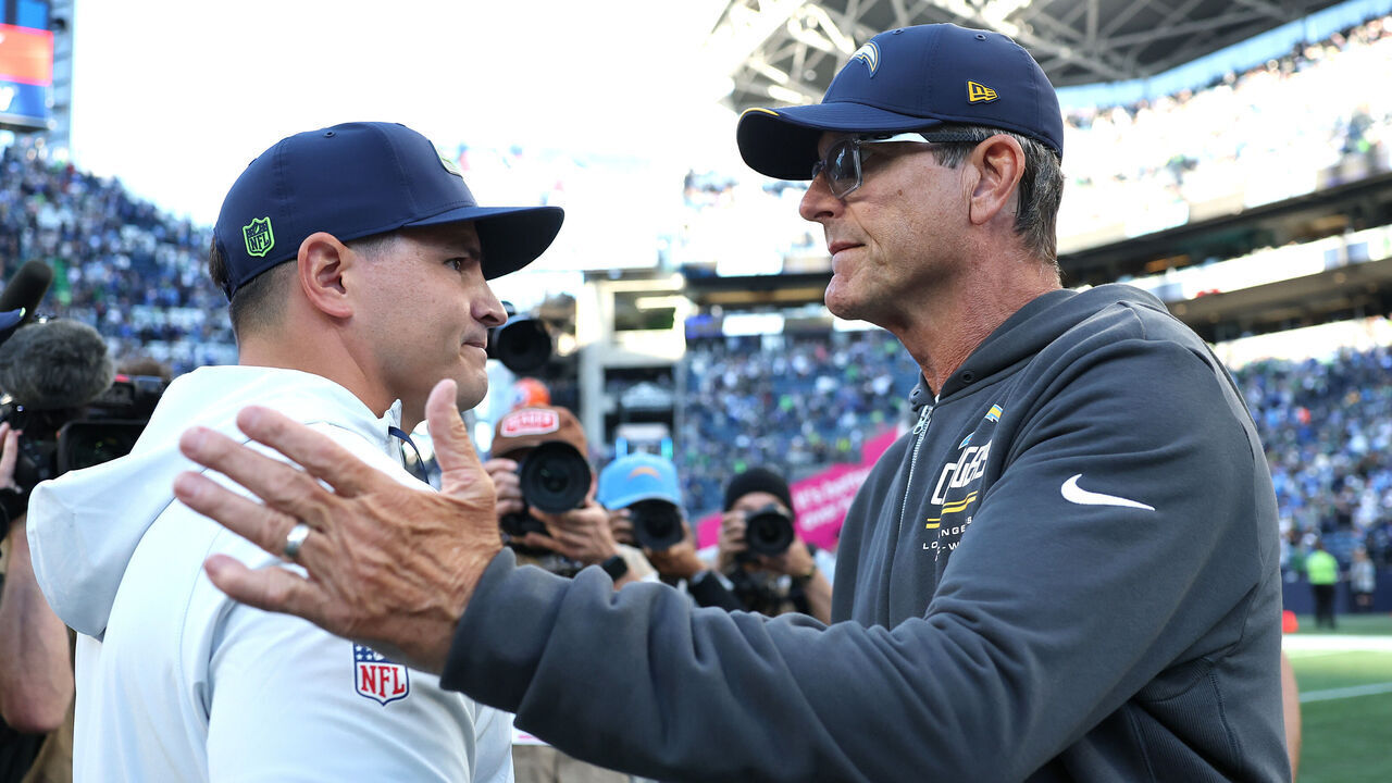 SEATTLE, WASHINGTON - OCTOBER 04: Head coach Jim Harbaugh of the Los Angeles Chargers and Head coach Mike MacDonald of the Seattle Seahawks shake hands after the game at Lumen Field on October 04, 2026 in Seattle, Washington.