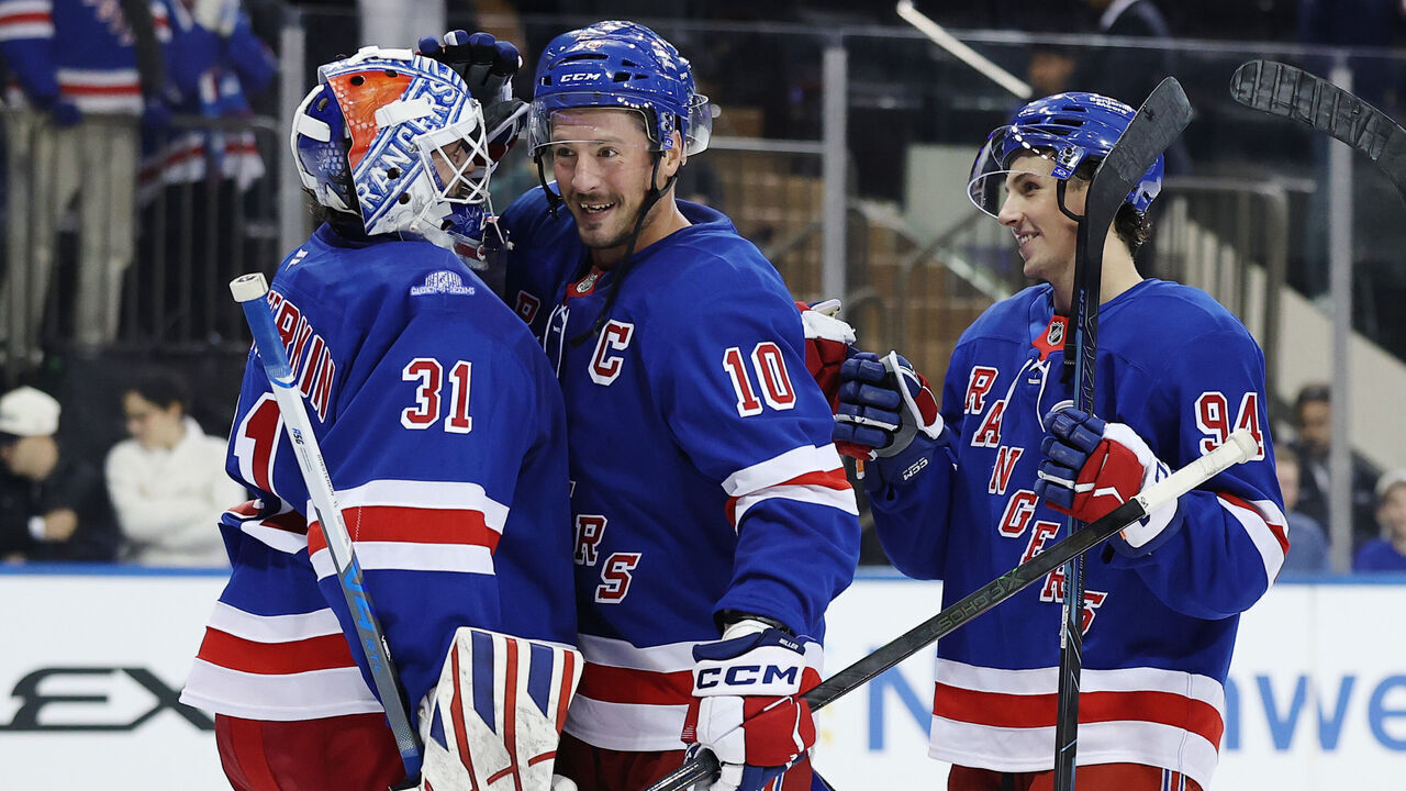 NEW YORK, NEW YORK - OCTOBER 04: J.T. Miller #10 and Gabe Perreault #94 celebrate with Igor Shesterkin #31 of the New York Rangers after the third period against the Utah Mammoth at Madison Square Garden on October 04, 2026 in New York City. The Rangers won 4-2.