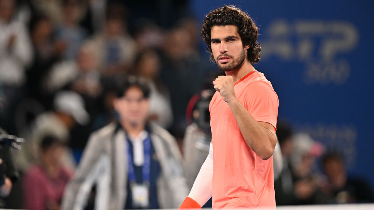 TOKYO, JAPAN - OCTOBER 05: Carlos Alcaraz of Spain plays a backhand against Jaume Munar of Spain during their singles match on day six of Kinoshita Group Japan Open at Ariake Tennis Park on October 05, 2026 in Tokyo, Japan.