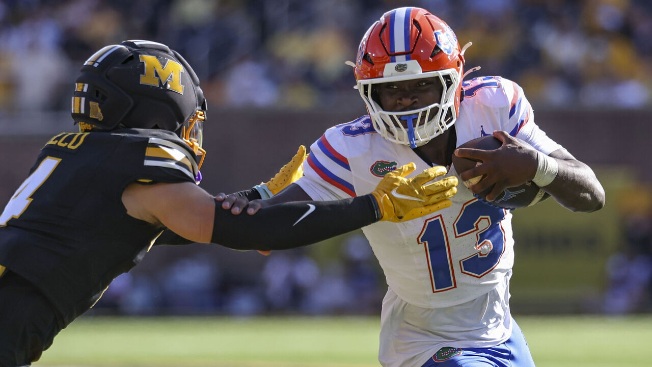 COLUMBIA, MO - OCTOBER 03: Jadan Baugh #13 of the Florida Gators stiff arms Trajen Greco #4 of the Missouri Tigers in the second quarter an SEC football game between the Florida Gators and Missouri Tigers on Oct 3, 2026 at Memorial Stadium in Columbia, MO.