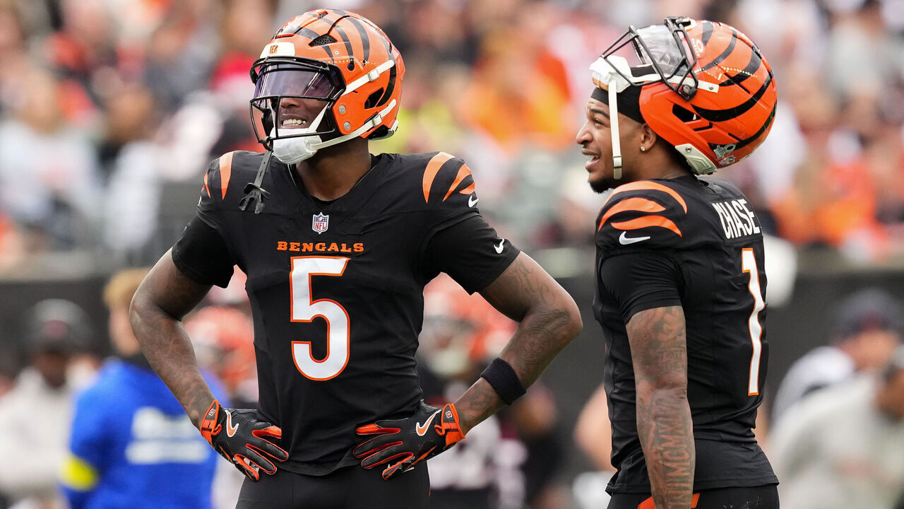 CINCINNATI, OHIO - DECEMBER 28: Tee Higgins #5 and Ja'Marr Chase #1 of the Cincinnati Bengals meet in the second quarter against the Arizona Cardinals at Paycor Stadium on December 28, 2025 in Cincinnati, Ohio.