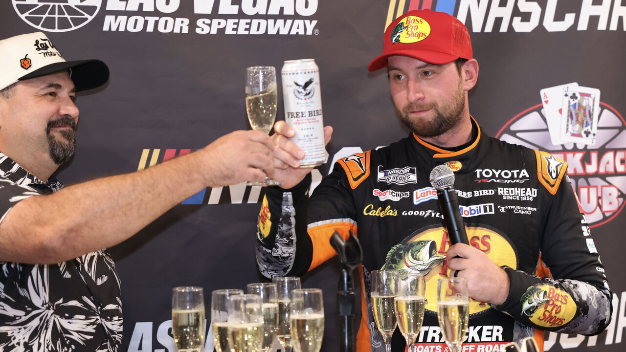 LAS VEGAS, CA - OCTOBER 04: Chase Briscoe (#19 Joe Gibbs Racing Bass Pro Shops Toyota) celebrates in in the LVMS Blackjack Club with Jose Castillo with a toast after winning the South Point 400 NASCAR Cup Series Chase playoff race on October 4, 2026 at Las Vegas Motor Speedway in Las Vegas, NV.