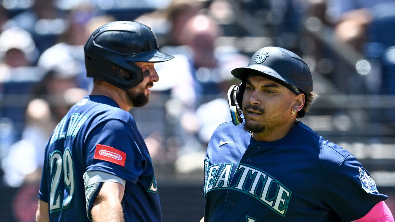 CLEVELAND, OHIO - JUNE 28: Josh Naylor #12 and Cal Raleigh #29 of the Seattle Mariners celebrate after Naylor scored on an error during the third inning against the Cleveland Guardians at Progressive Field on June 28, 2026 in Cleveland, Ohio.