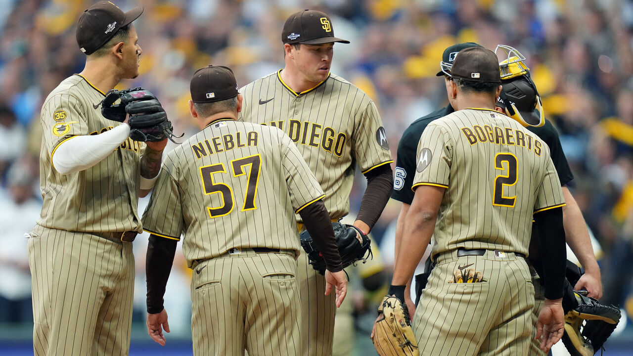 MILWAUKEE, WISCONSIN - OCTOBER 04: Mason Miller #22 of the San Diego Padres has a mound visit against the Milwaukee Brewers during the ninth inning in game two of the National League Division Series at American Family Field on October 04, 2026 in Milwaukee, Wisconsin.