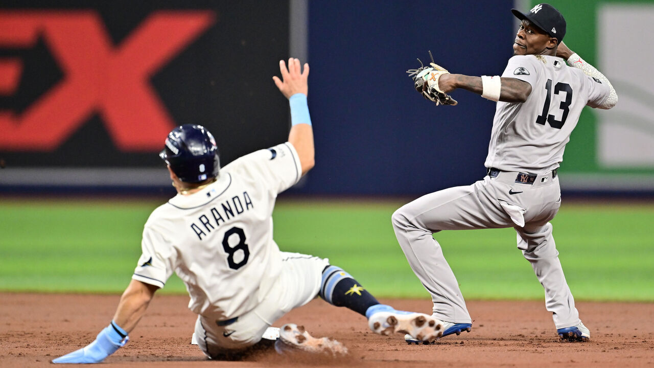 ST PETERSBURG, FLORIDA - OCTOBER 05: Jonathan Aranda #8 of the Tampa Bay Rays is out at second base as Jazz Chisholm Jr. #13 of the New York Yankees attempts to turn a double play during the first inning in game two of the American League Division Series at Tropicana Field on October 05, 2026 in St Petersburg, Florida. Chisholm was given an error on the throw on this play.