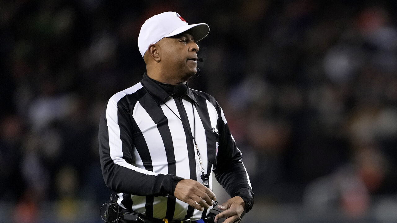 CHICAGO, ILLINOIS - JANUARY 10: Referee Adrian Hill #29 officiates between the Chicago Bears and the Green Bay Packers in the NFC Wild Card Playoff game at Soldier Field on January 10, 2026 in Chicago, Illinois.