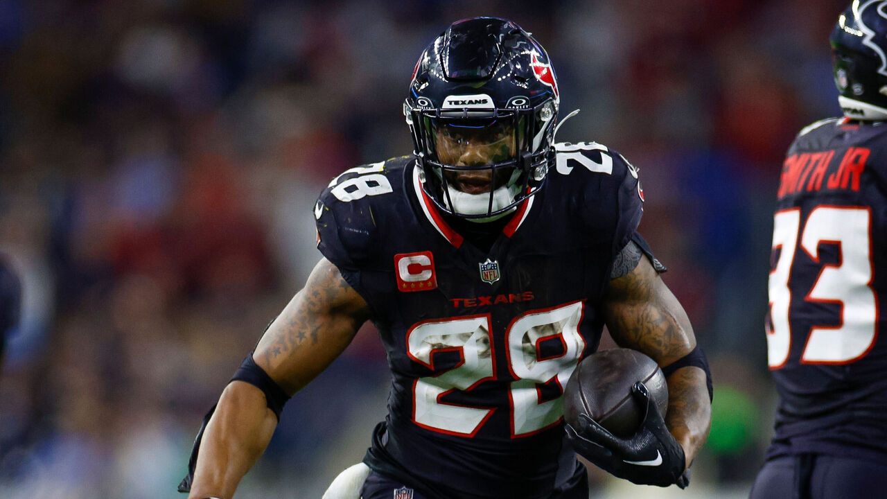 HOUSTON, TEXAS - JANUARY 11: Joe Mixon #28 of the Houston Texans carries the ball on a running play for a touchdown during the second half of the AFC Wild Card Playoff game against the Los Angeles Chargers at NRG Stadium on January 11, 2025 in Houston, Texas.