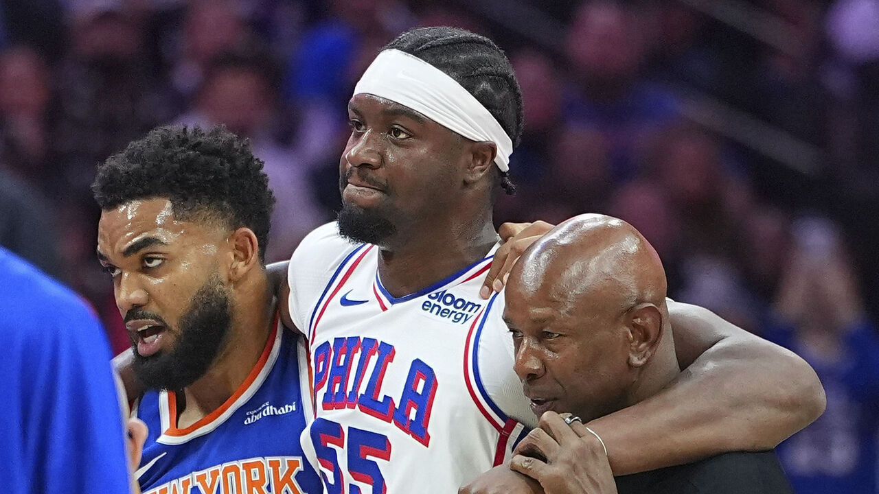 PHILADELPHIA, PENNSYLVANIA - OCTOBER 5: Ariel Hukporti #55 of the Philadelphia 76ers is helped off the court after an injury against the New York Knicks during a preseason game at Xfinity Mobile Arena on October 5, 2026 in Philadelphia, Pennsylvania. The 76ers defeated the Knicks 120-97.