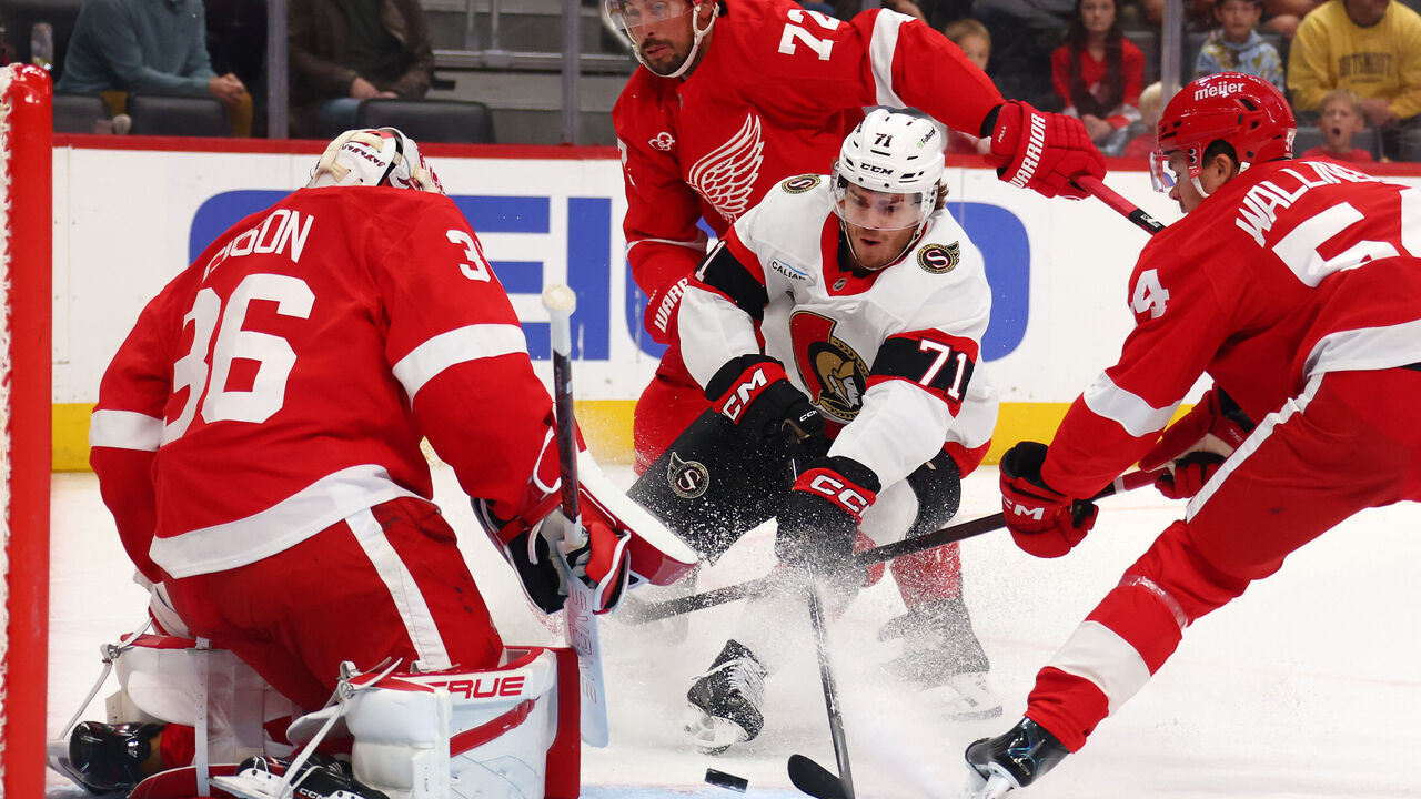 DETROIT, MICHIGAN - OCTOBER 06: Ridly Greig #71 of the Ottawa Senators tries to get a shot off in the first period around John Gibson #36 of the Detroit Red Wings at Little Caesars Arena on October 06, 2026 in Detroit, Michigan.