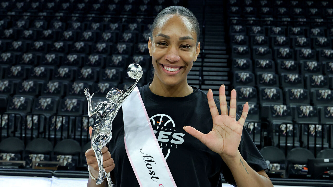 LAS VEGAS, NEVADA - OCTOBER 08: A'ja Wilson #22 of the Las Vegas Aces poses with the 2026 WNBA MVP award, her third consecutive and fifth career trophy, after a team walkthrough at Michelob ULTRA Arena on October 8, 2026 in Las Vegas, Nevada. Wilson captured her previous MVP awards in the 2020, 2022, 2024, and 2025 seasons.