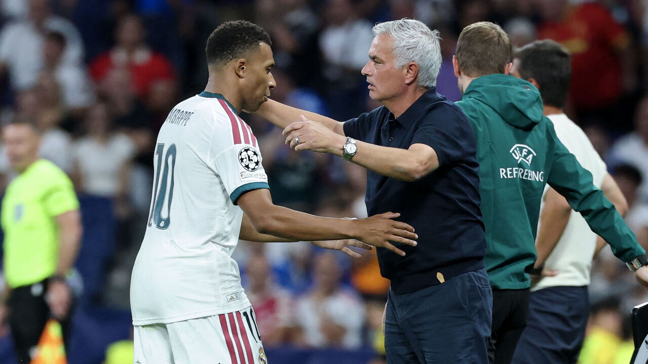 Real Madrid's Portuguese coach Jose Mourinho (R) embraces Real Madrid's French forward #10 Kylian Mbappe as he leaves the pitch to be substituted during the UEFA Champions League first round day 1 football match between Real Madrid and Inter Milan at the Santiago Bernabeu stadium in Madrid on September 8, 2026.