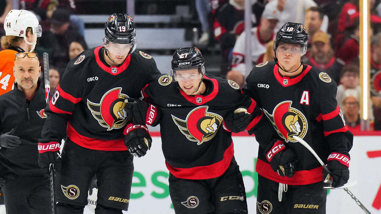 OTTAWA, CANADA - OCTOBER 08: William Eklund #27 of the Ottawa Senators is assisted off the ice by his teammates Drake Batherson #19 and Tim Stützle #18 after an injury in the first period against the Philadelphia Flyers at Canadian Tire Centre on October 08, 2026 in Ottawa, Ontario, Canada.