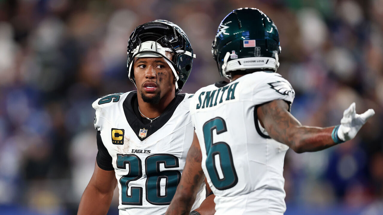 EAST RUTHERFORD, NEW JERSEY - OCTOBER 09: Saquon Barkley #26 of the Philadelphia Eagles talks with Devonta Smith #6 during the second quarter of the game against the New York Giants at MetLife Stadium on October 09, 2025 in East Rutherford, New Jersey.