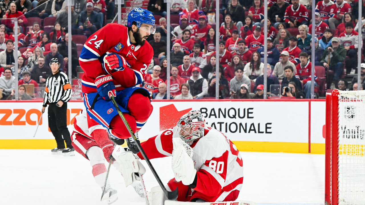 MONTREAL, CANADA - OCTOBER 10: Phillip Danault #24 of the Montréal Canadiens jumps in front of goaltender Daniil Tarasov #80 of the Detroit Red Wings during the second period at the Bell Centre on October 10, 2026 in Montreal, Quebec, Canada.