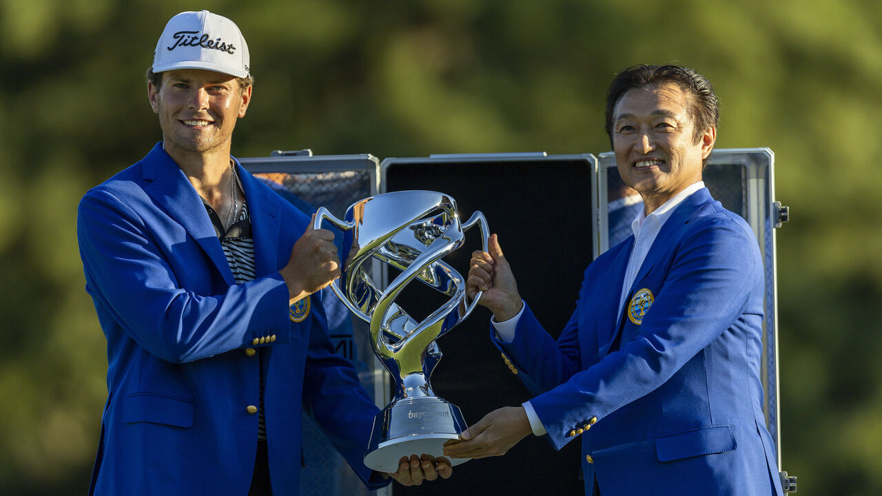 YOKOHAMA, JAPAN - OCTOBER 11: Michael Brennan of the United States is presented the trophy at the ceremony following the final round of the Baycurrent Classic 2026 at Yokohama Country Club on October 11, 2026 in Yokohama, Kanagawa, Japan
