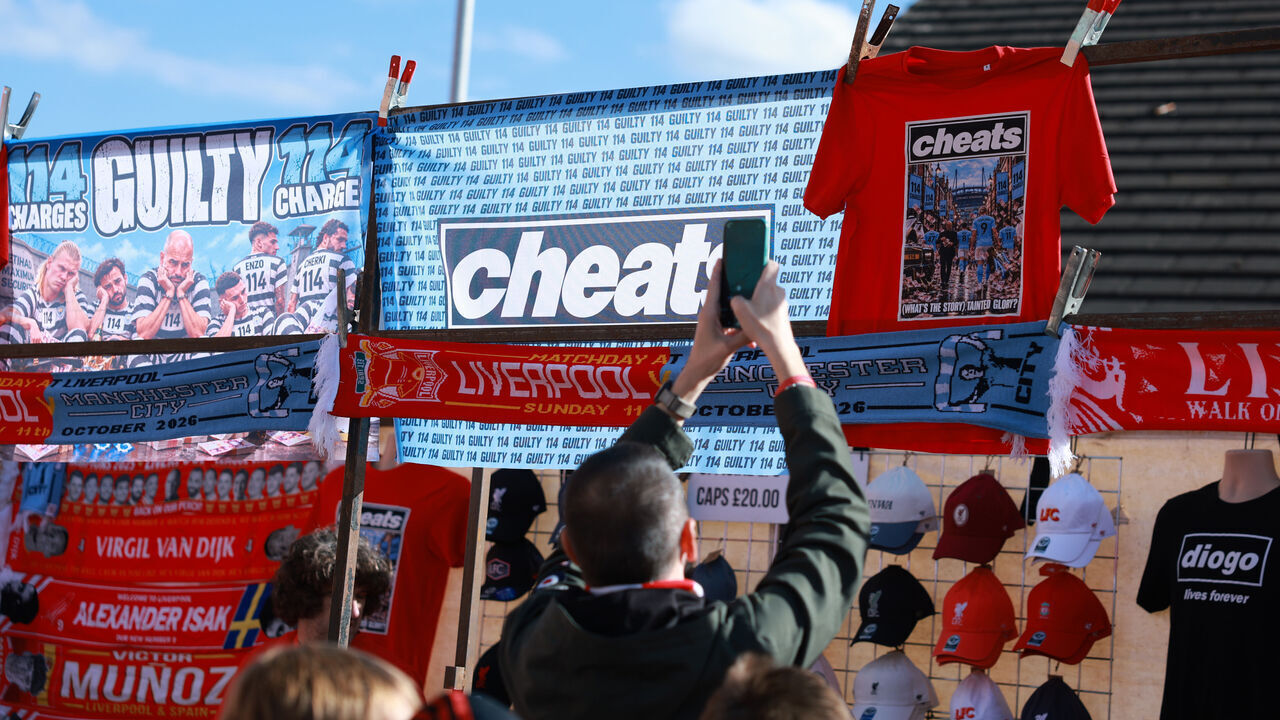 LIVERPOOL, ENGLAND - OCTOBER 11: A Liverpool merchandise stand is seen selling flags and t-shirts that read "Cheats" aimed towards Manchester City before the Premier League 2026/27 match between Liverpool FC and Manchester City at Anfield on October 11, 2026 in Liverpool, England.