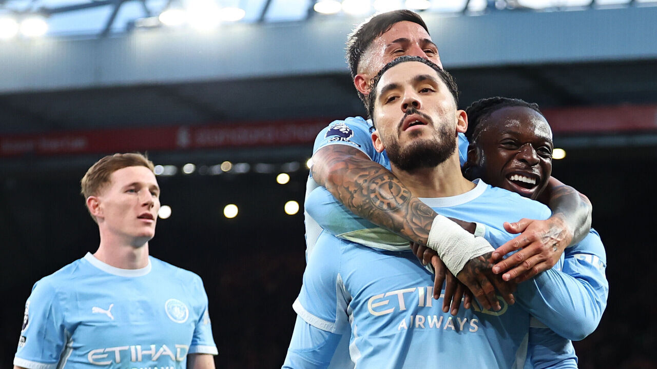 LIVERPOOL, ENGLAND - OCTOBER 11: Rayan Cherki of Manchester City celebrates scoring their third goal with Jeremy Doku, Enzo Fernandez during the Premier League 2026/27 match between Liverpool FC and Manchester City at Anfield on October 11, 2026 in Liverpool, England.