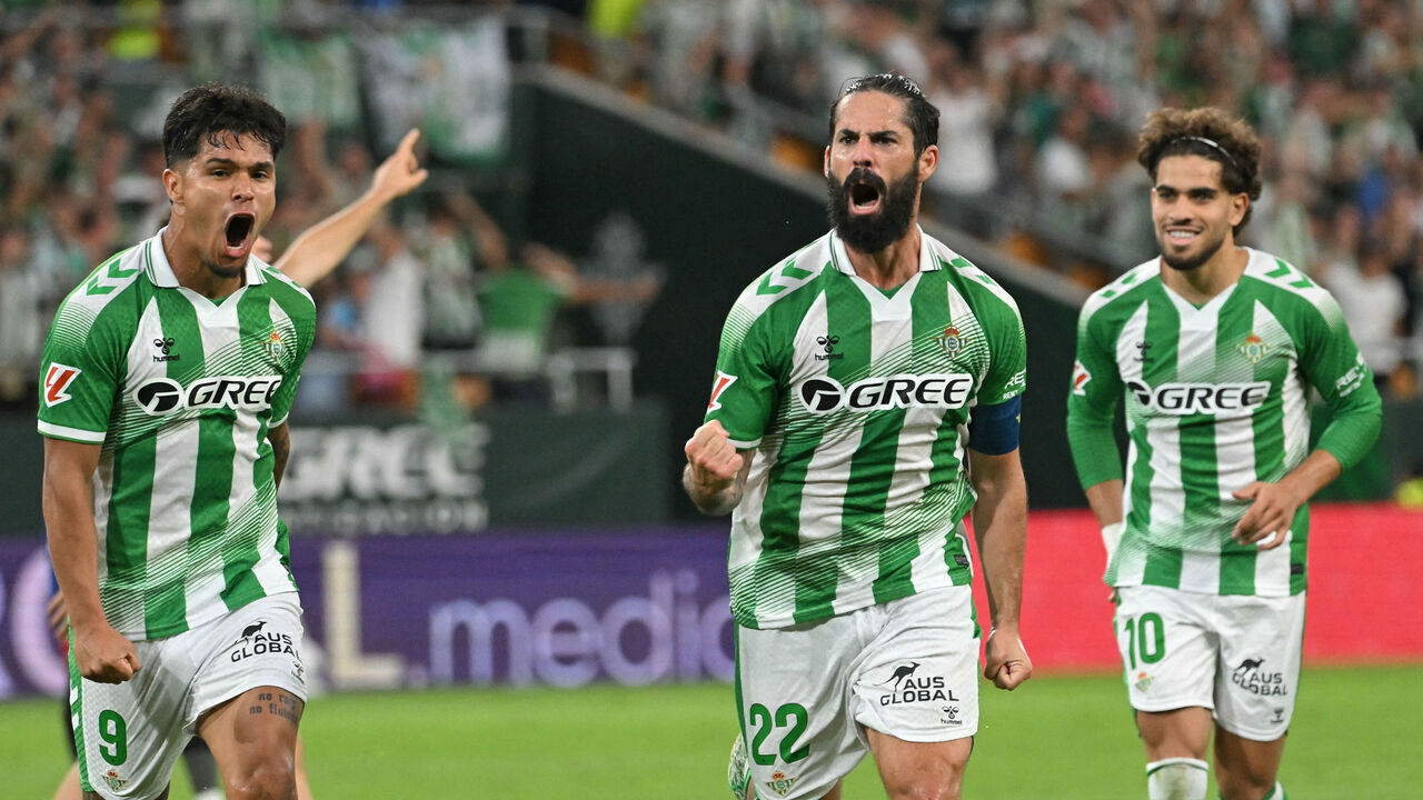 Real Betis' Spanish midfielder #22 Isco (2R) celebrates scoring his team's fourth goal during the Spanish league football match between Real Betis and CA Osasuna at Benito Villamarin Stadium in Seville on October 11, 2026.
