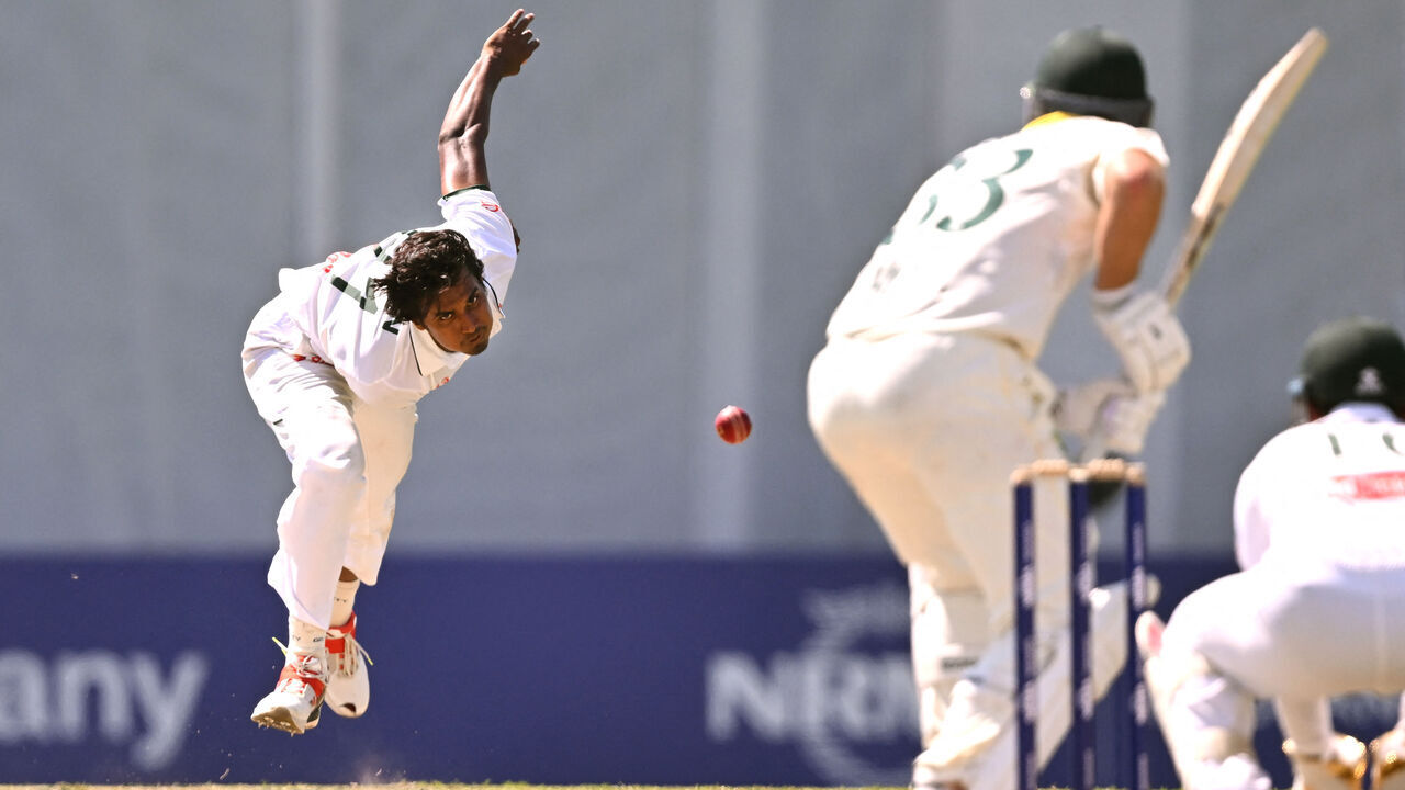 Bangladesh bowler Hasan Mahmud (L) sends down a delivery on the third day of the first cricket Test match between Australia and Bangladesh at Marrara Stadium in Darwin on August 15, 2026. / --IMAGE RESTRICTED TO EDITORIAL USE - STRICTLY NO COMMERCIAL USE--