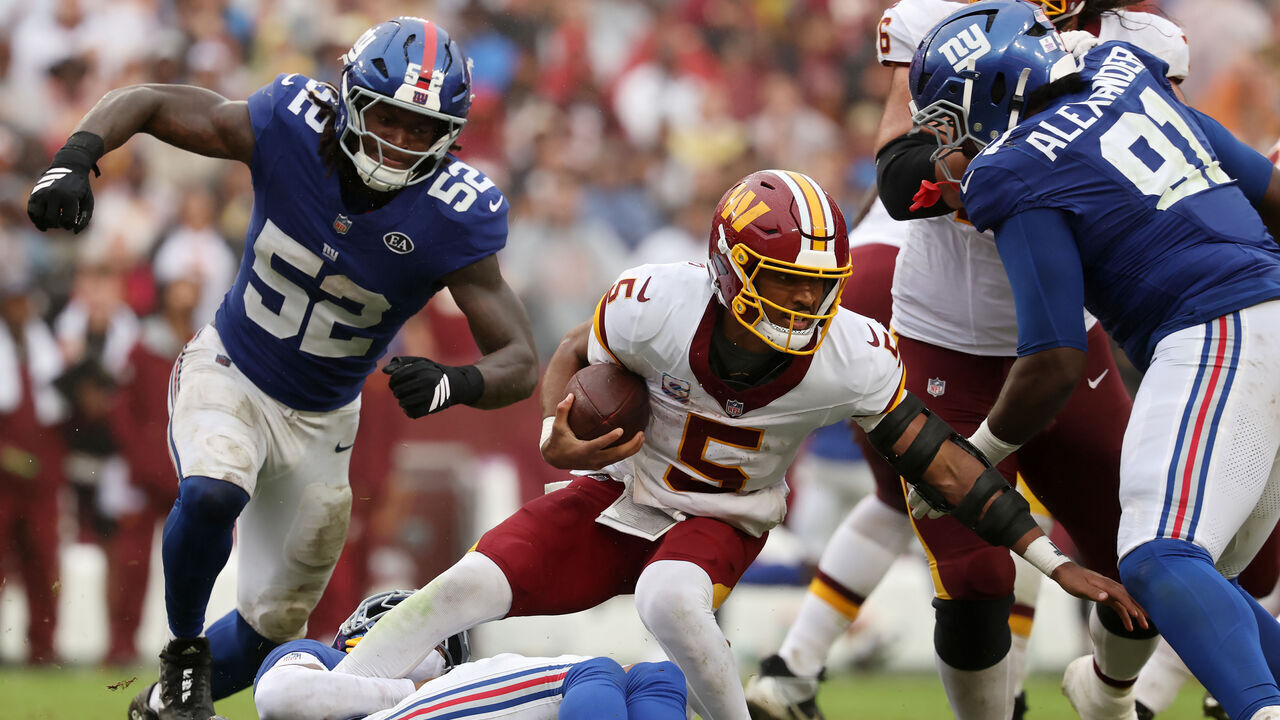 LANDOVER, MARYLAND - OCTOBER 11: Jayden Daniels #5 of the Washington Commanders is sacked by Andru Phillips #22 of the New York Giants during the fourth quarter of the game at Northwest Stadium on October 11, 2026 in Landover, Maryland.