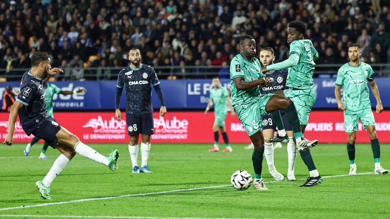 Marseille's Moroccan forward #77 Amine Harit (L) shoots to score a goal during the French L1 football match between ES Troyes AC and Olympique de Marseille (OM) at the Stade de l'Aube in Troyes, central France, on October 11, 2026.