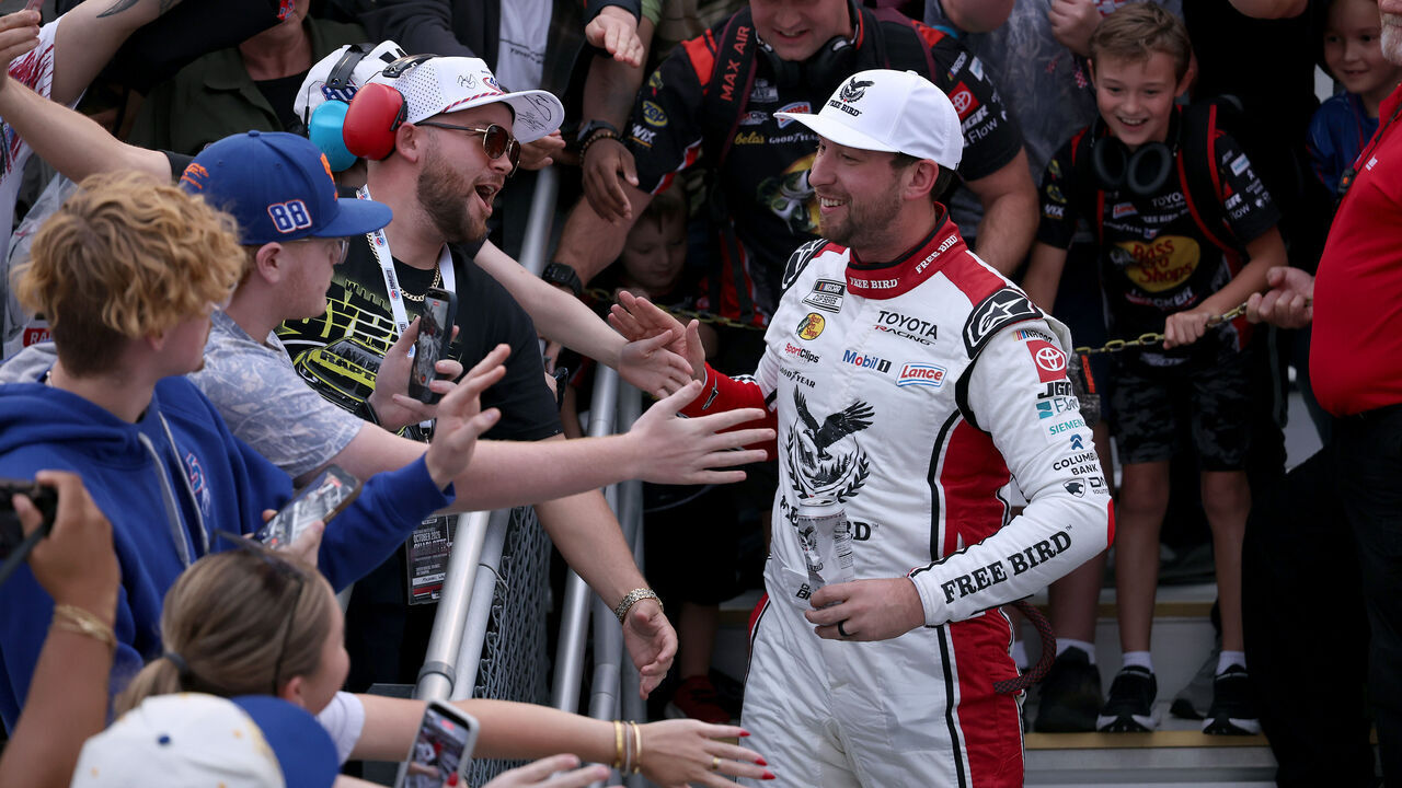 CONCORD, NORTH CAROLINA - OCTOBER 11: Chase Briscoe, driver of the #19 Freebird Spring Water Toyota, celebrates with fans in the grandstands after winning the NASCAR Cup Series Bank of America 400 at Charlotte Motor Speedway on October 11, 2026 in Concord, North Carolina.