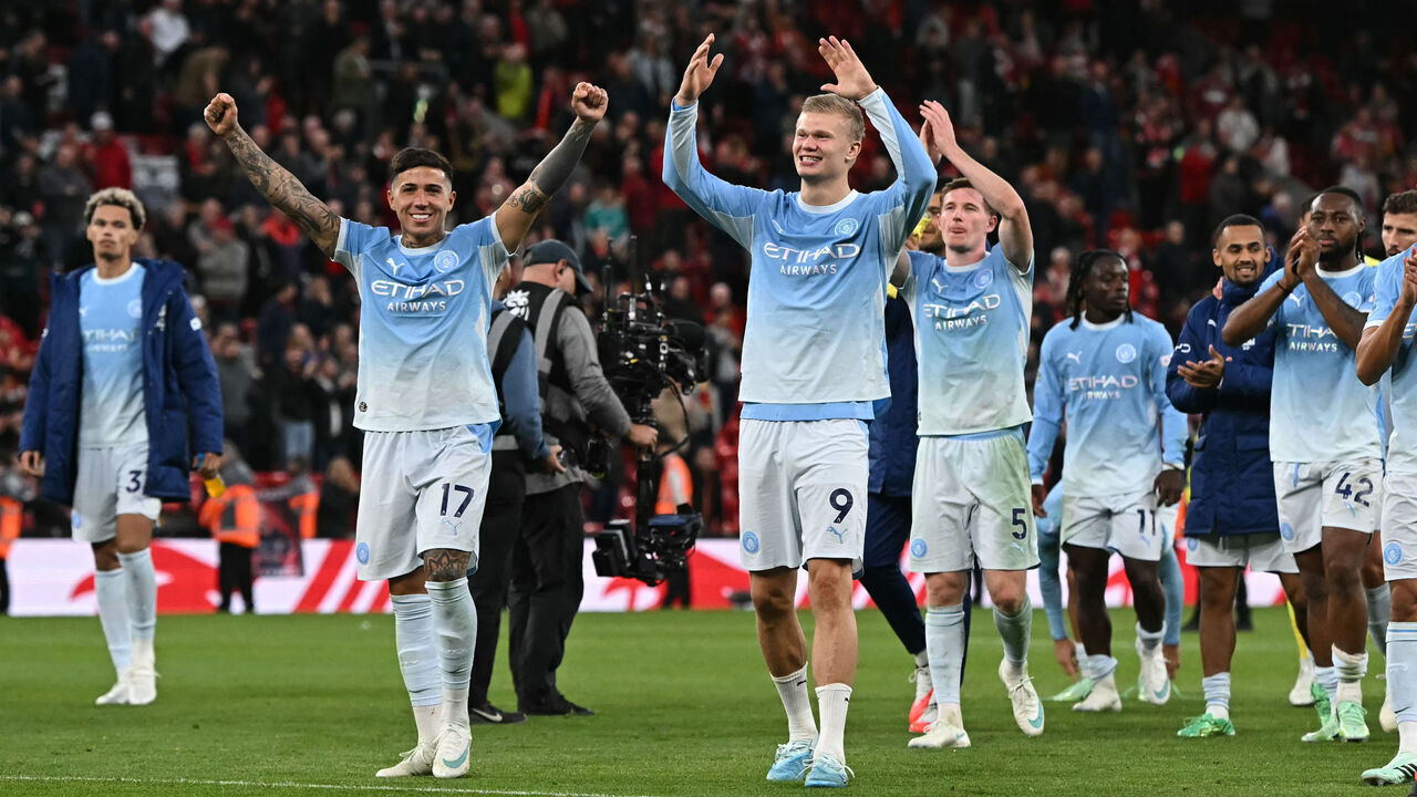 Manchester City's players celebrate on the pitch after the English Premier League football match between Liverpool and Manchester City at Anfield in Liverpool, north west England on October 11, 2026. Manchester City won the game 3-0. / RESTRICTED TO EDITORIAL USE. No use with unauthorized audio, video, data, fixture lists, club/league logos or 'live' services. Online in-match use limited to 120 images. An additional 40 images may be used in extra time. No video emulation. Social media in-match use limited to 120 images. An additional 40 images may be used in extra time. No use in betting publications, games or single club/league/player publications. /