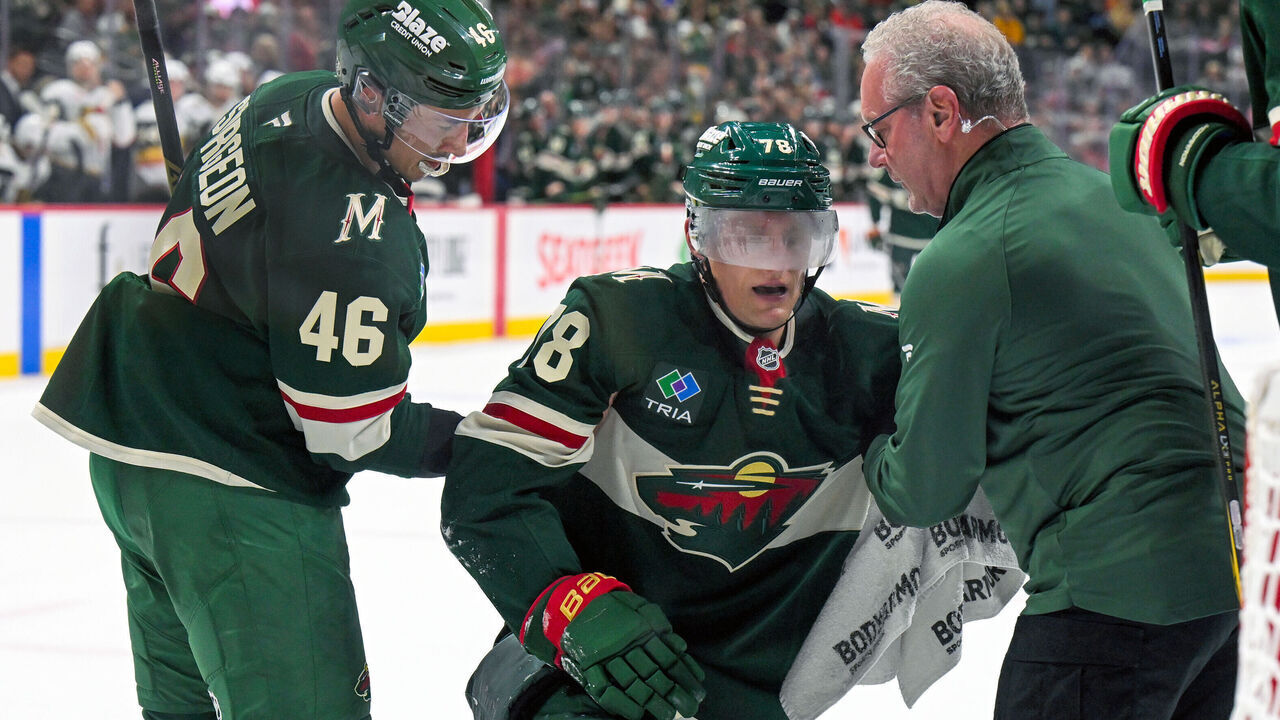 SAINT PAUL, MN - OCTOBER 12: Minnesota Wild defensemen Jared Spurgeon (46) and Minnesota Wild head athletic trainer John Worley assist Minnesota Wild forward Nico Sturm (78) to his feet after he took a puck to the side of the head during the first period of an NHL game between the Minnesota Wild and Vegas Golden Knights on October 12, 2026, at Grand Casino Arena in St. Paul, MN.