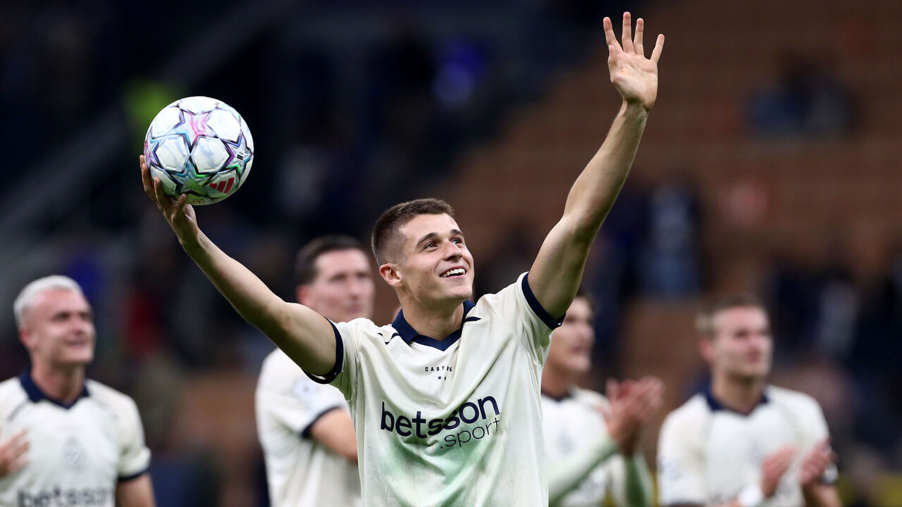 MILAN, ITALY - OCTOBER 13: Nicolo Tresoldi of Club Brugge KV acknowledges the fans whilst holding the match ball after scoring a hat-trick in the UEFA Champions League 2026/27 League Phase MD2 match between FC Internazionale Milano and Club Brugge KV at Stadio San Siro on October 13, 2026 in Milan, Italy.